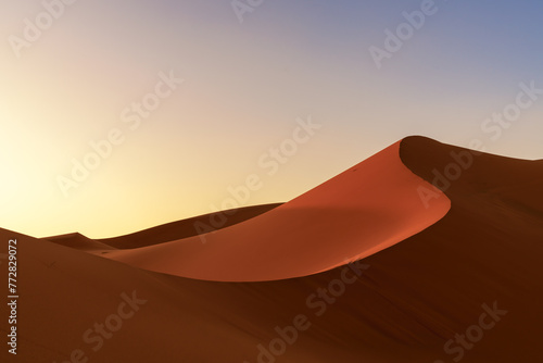 view of the sand dunes at Erg Chebbi in Morocco in warm evening light photo