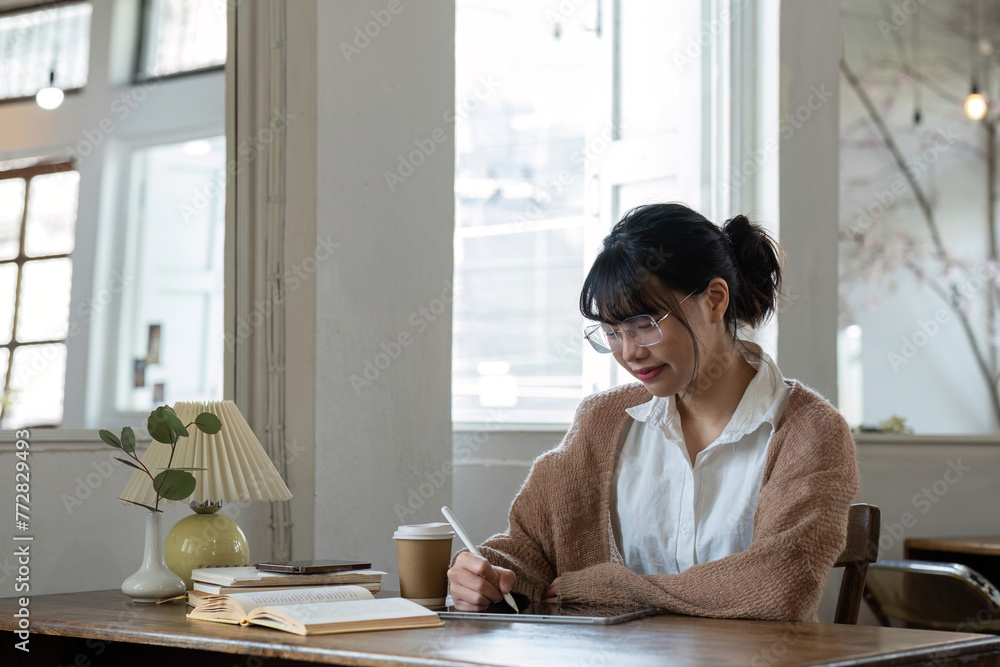 Young girl sits online studying and doing online homework at home on a special holiday.