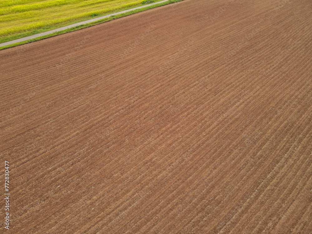 Aerial view of a brown plowed farm field with soil Aerial view of a brown plowed farm field with soil