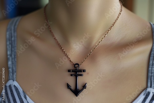 a person wearing an anchorshaped necklace photo