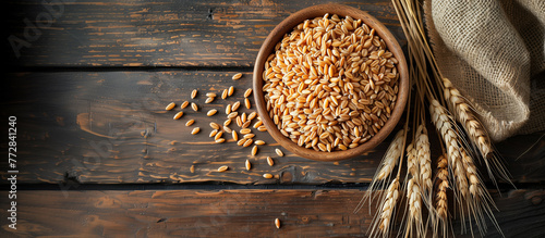 Top view of wholegrain spelt farro in bowl on rustic wooden background photo