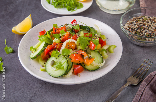 Salad of fresh cucumbers, celery, sweet peppers, herbs and pumpkin seeds, sunflowers, sesame seeds with olive oil. Healthy vegetarian, vegan food. Italian Cuisine
