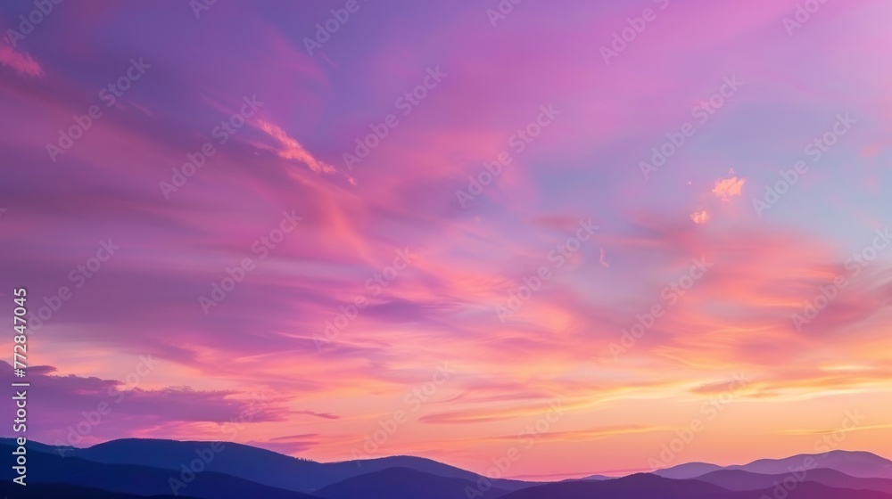 Vibrant sunset skies over mountain silhouette