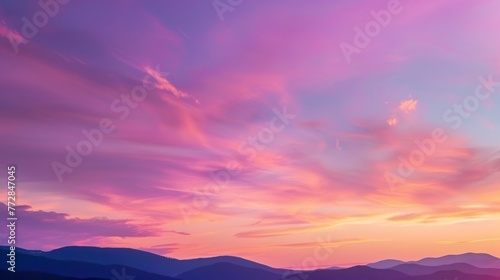 Vibrant sunset skies over mountain silhouette