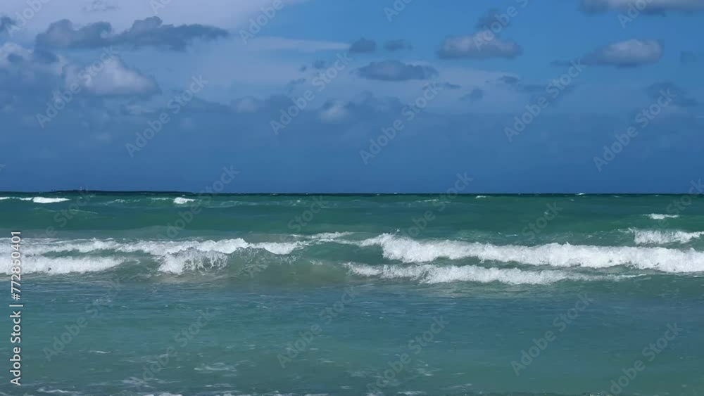 A beautiful Cuban beach in Varadero, Cuba, where you can see the waves and ocean waters on a cloudy day with the sun breaking through the clouds. Turquoise waves. 4K Video A beautiful Cuban beach in Varadero, Cuba, where you can see the waves and ocean waters on a cloudy day with the sun breaking through the clouds. Turquoise waves. 4K Video