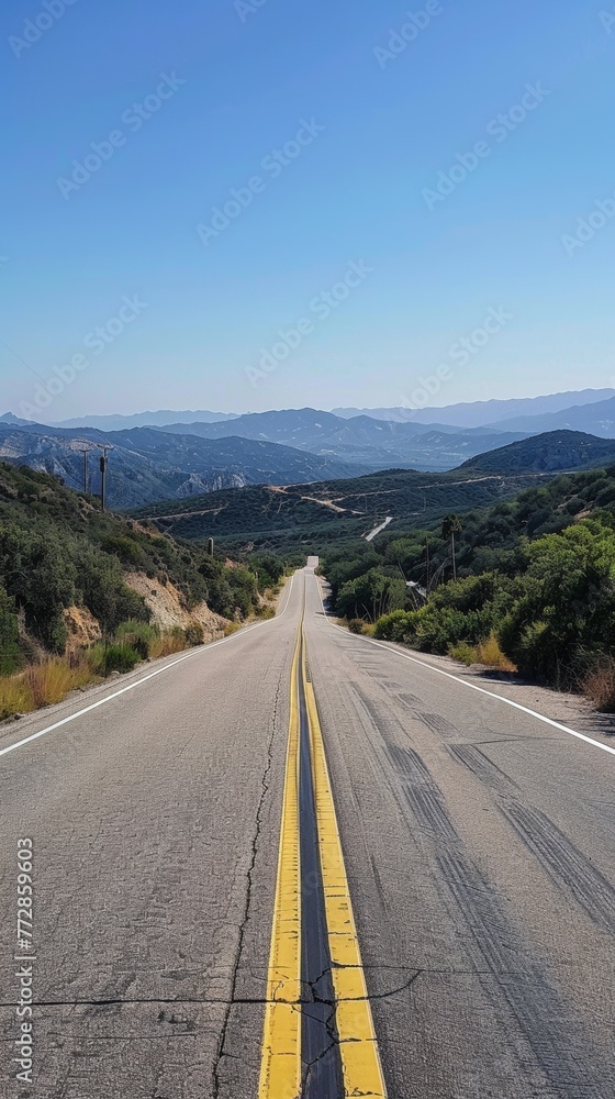 Open road through rolling hills Open road through rolling hills