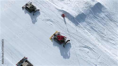 Snow Groomer and Piste Basher Working on a Ski Piste Aerial View photo