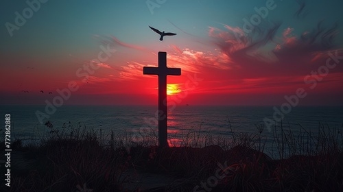 Silhouette of a cross at sunset on a coastal landscape