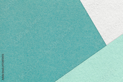 Texture of craft dark cyan color paper background with white and mint border. Vintage abstract green cardboard.