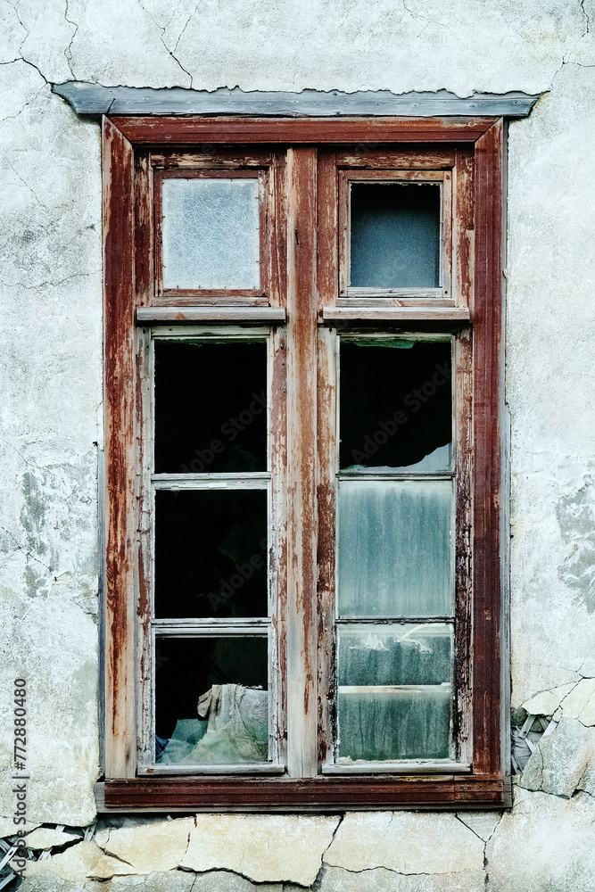 The seaside house has long been abandoned. An old ruined window in house on sea of Arctic Ocean