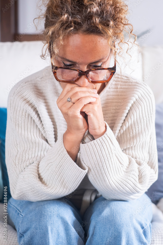 Unhappy adult lonely woman indoor sit on sofa at home and looking at window, thinking about problem and trouble, suffering from depression or loneliness, mental illness, makes difficult decisions Unhappy adult lonely woman indoor sit on sofa at home and looking at window, thinking about problem and trouble, suffering from depression or loneliness, mental illness, makes difficult decisions