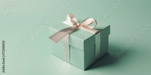 Gift box. Elegant green present box with white silk bow on a green pastel background, copy space. Beautiful Background for greeting card for Birthday, Mother's Day, Wedding, Valentine's Day