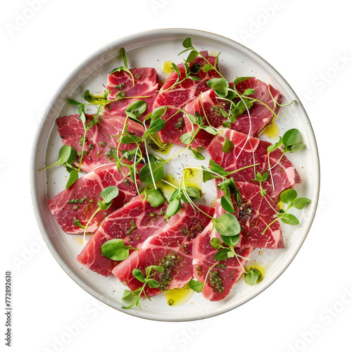 A thinly sliced, marbled Wagyu beef carpaccio, drizzled with truffle oil and sprinkled with microgreens on a white plate.