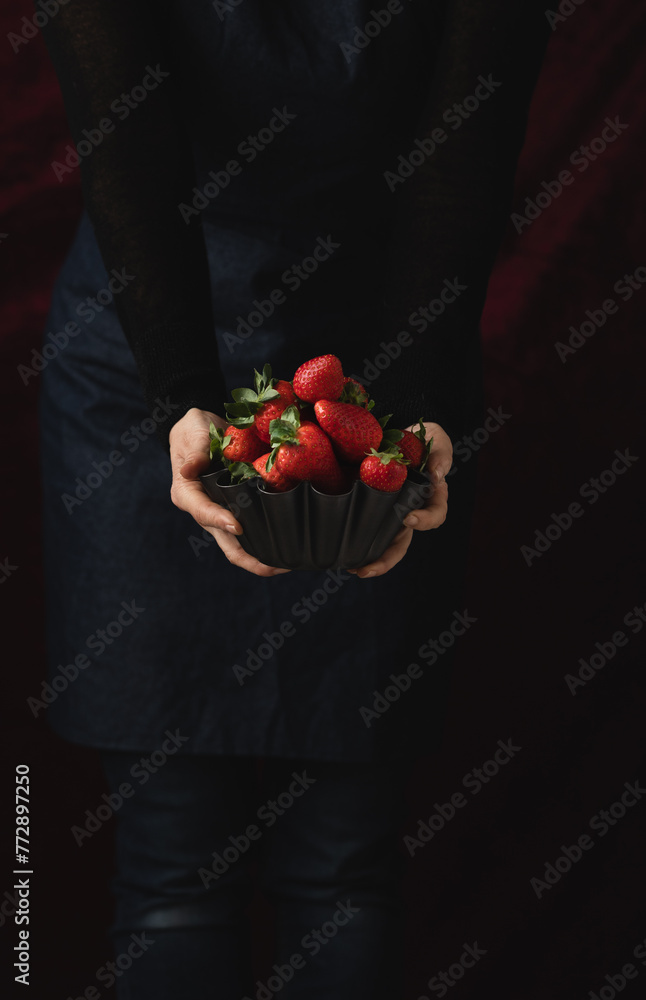 Delicious, ripe, red strawberries in a metallic bowl against a black background Delicious, ripe, red strawberries in a metallic bowl against a black background