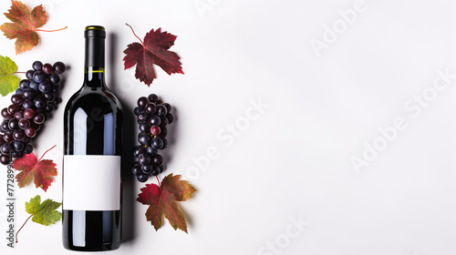 a bottle of wine next to grapes