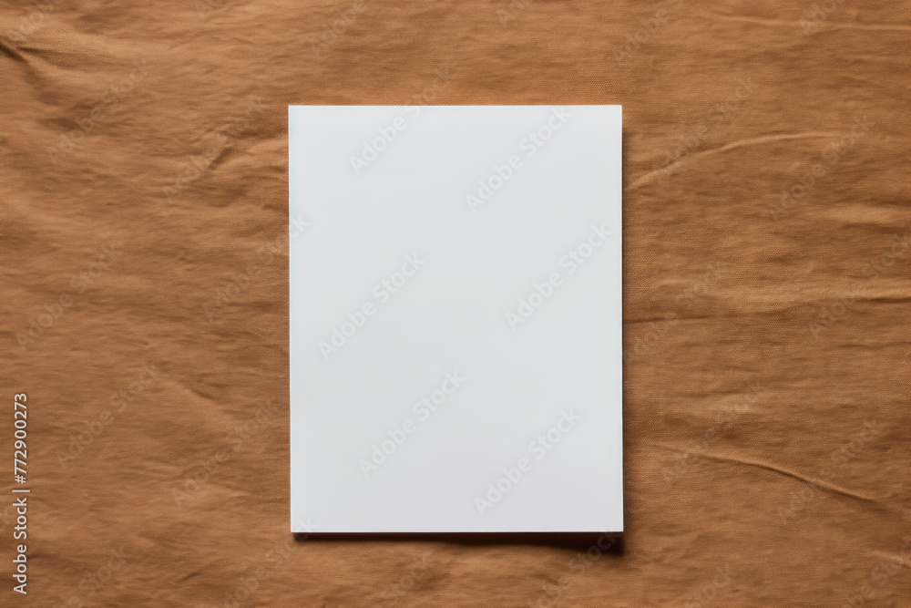 Blank white vertical paper on a crumpled brown paper background. Blank white vertical paper on a crumpled brown paper background.