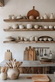 Neutral toned kitchenware display on open shelving.