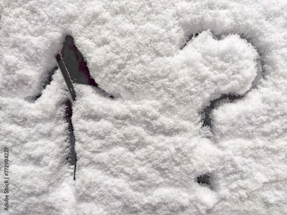 A question mark and arrow written in the snow. The cold frosty texture ...