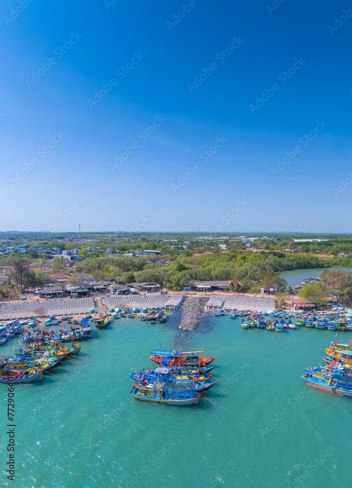 Aerial view of Loc An fishing village, Vung Tau city. A fishing port with tsunami protection concrete blocks. Cityscape and traditional boats in the sea.