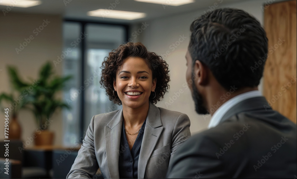 A black businesswoman t is having a cheerful conversation with customers office. A black businesswoman t is having a cheerful conversation with customers office.