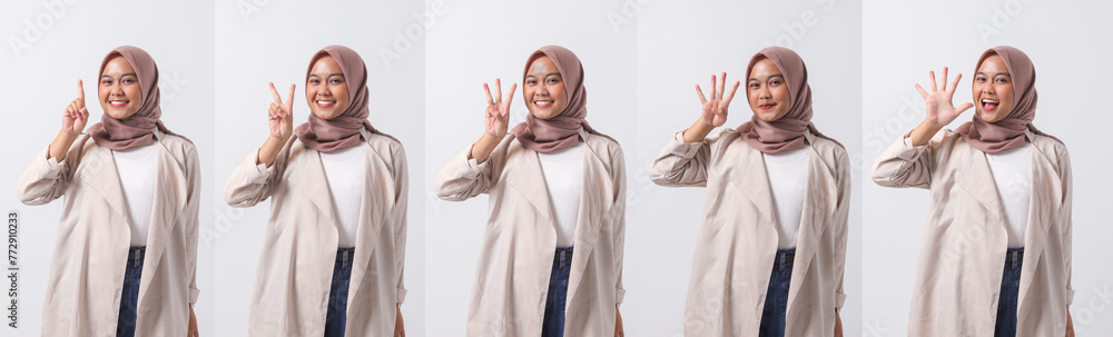 Set image of excited Asian hijab woman in casual suit showing and pointing up with fingers number while smiling confident and happy. Businesswoman concept. Isolated image on white background