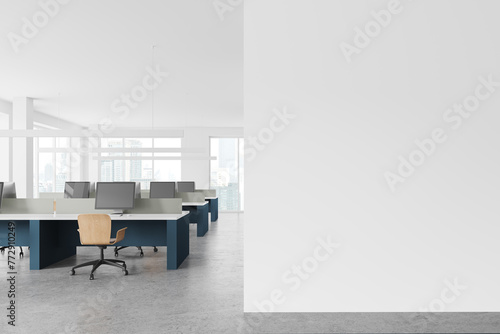 White open space office interior with blue desks and blank wall