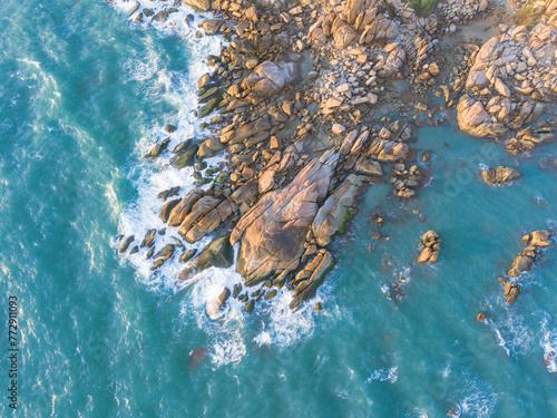 Aerial drone top view of beautiful waves crashing on the rocky island coast, ocean waves and fantastic. Ocean in Vietnam.