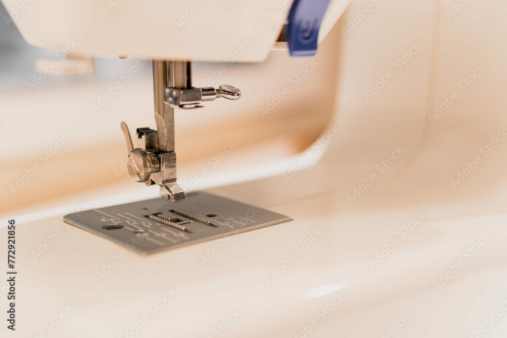 Closeup White Sewing Machine Foot Blurred Background