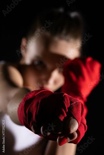 The athlete hits the fist straight ahead. Technical training before the fight in the ring. © fotodrobik