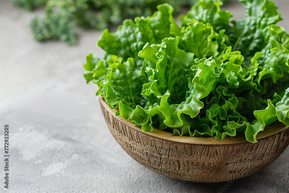 Close-up of a wooden bowl overflowing with green lettuce leaves