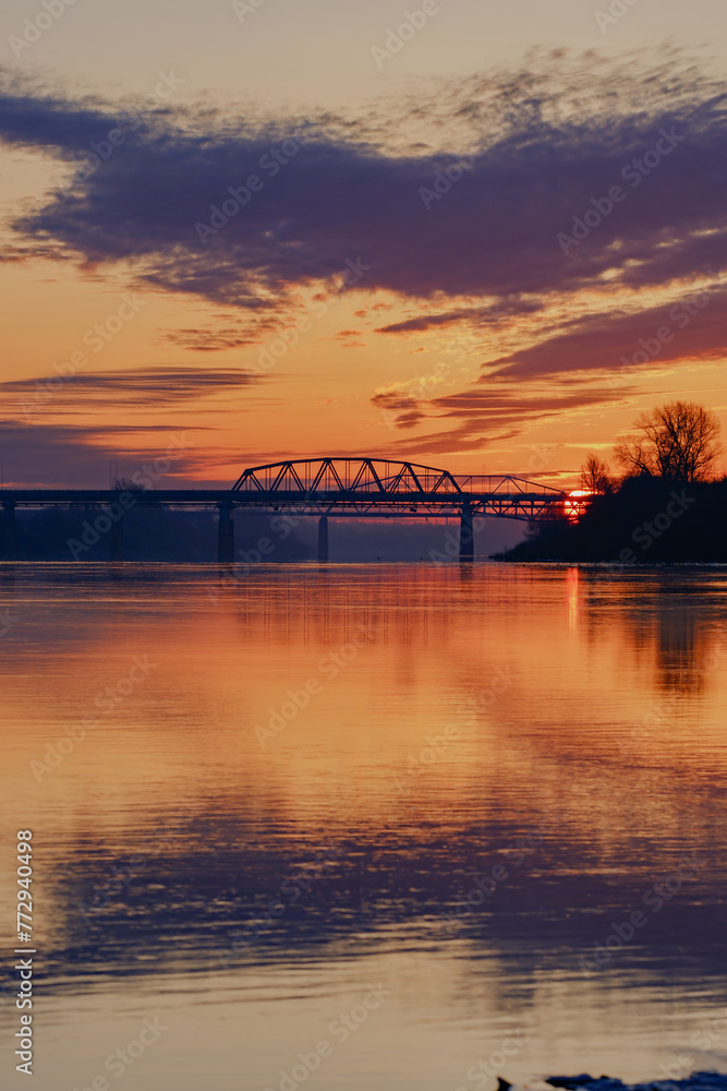Fototapeta premium Morning dawn landscape with a view of the bridges and the reflection of the colorful sky in the water