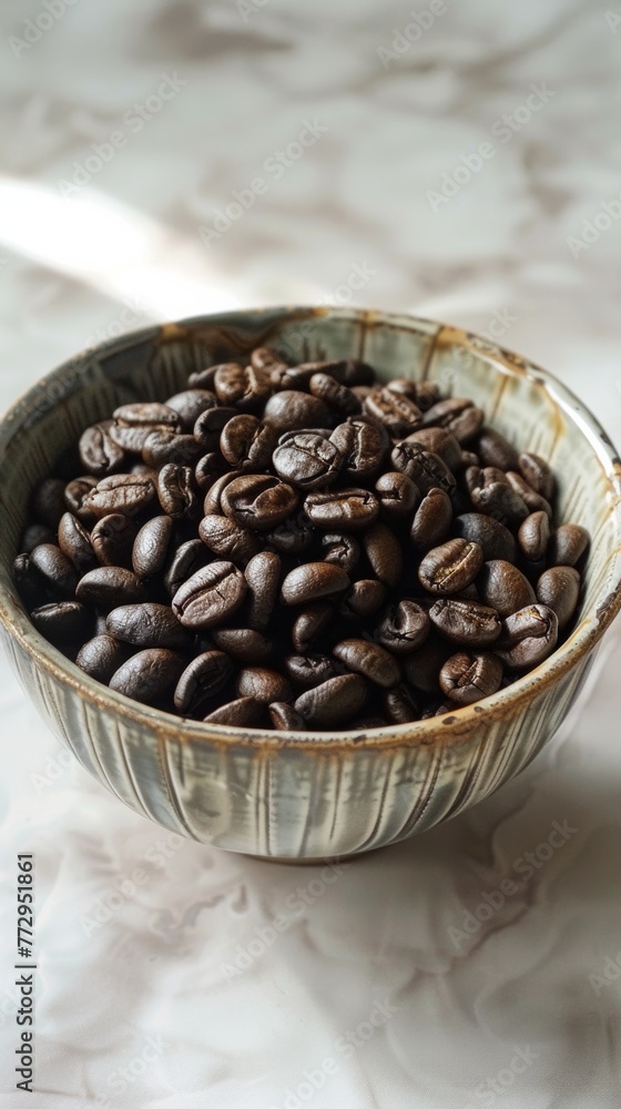 Fototapeta premium Bowl of fresh coffee beans on a textured surface