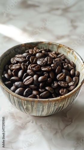 Bowl of fresh coffee beans on a textured surface