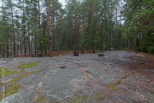 Public fire place and wooden bench at Sarvikallio in autumn, Tuusula, Finland. photo