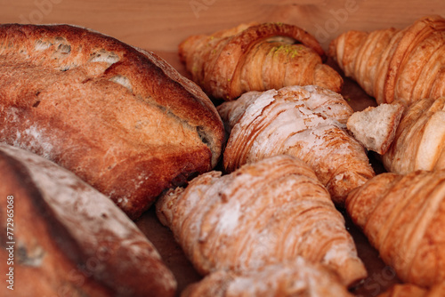Freshly baked french croissants and crispy bread. Assortment of baked goods on the counter