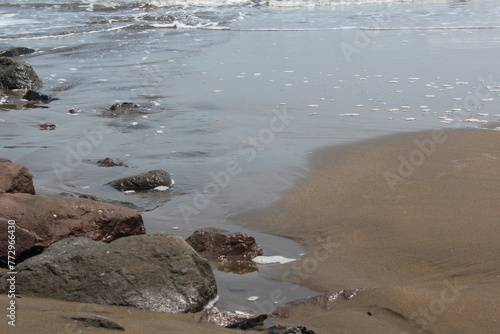 Image of a romantic view of a beach with sand and rocks