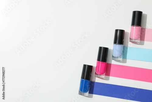Multicolored Nail Polishes White Background © Furqan
