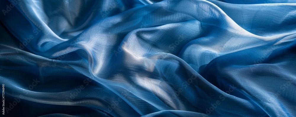 Fototapeta premium Textured blue silk fabric with waves