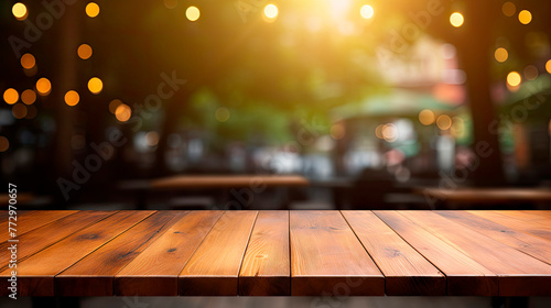 Empty wooden table with blurry lights in the backdrop