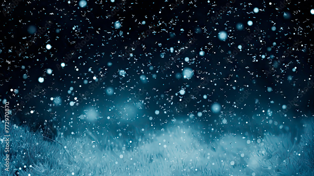 Snowflakes falling on a field under a blue sky