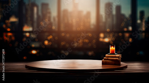 A table with candle and books in front of cityscape