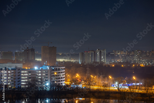 Night cityscape of the big city. Bright, multi colored light on empty streets. Apartment buildings in bedroom town area. Kyiv in end of march 2024. Ukraine. © Sodel Vladyslav
