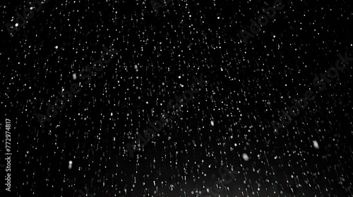 Snow falling against a dark background with a street light photo