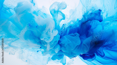 Blue ink swirling in clear water on white backdrop