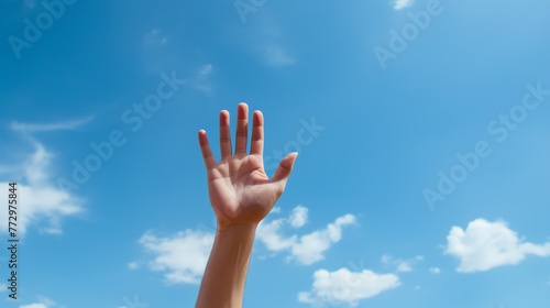 a hand reaching out to the sky