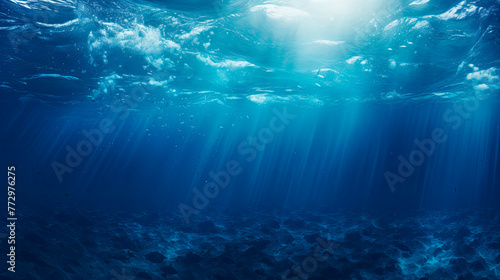 Sunlight filtering through deep blue ocean water © StockKing