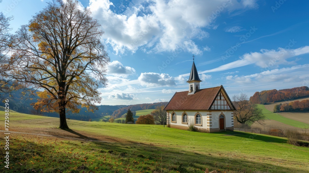 A panoramic view of a small chapel nestled in a picturesque countryside.