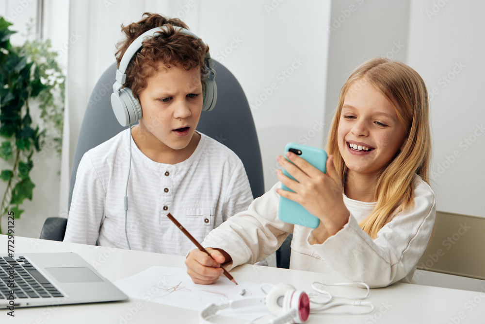 Happy Caucasian Kids Studying and Playing with Laptops at Home Happy Caucasian Kids Studying and Playing with Laptops at Home