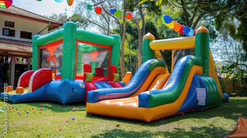 A birthday party with a bounce house and inflatable slide.