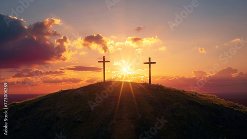 Three crosses stand a hill at sunset